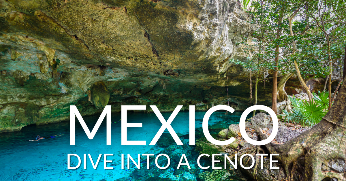 People swimming in clear blue water in Cenote Dos Ojos in Quintana Roo, Mexico.