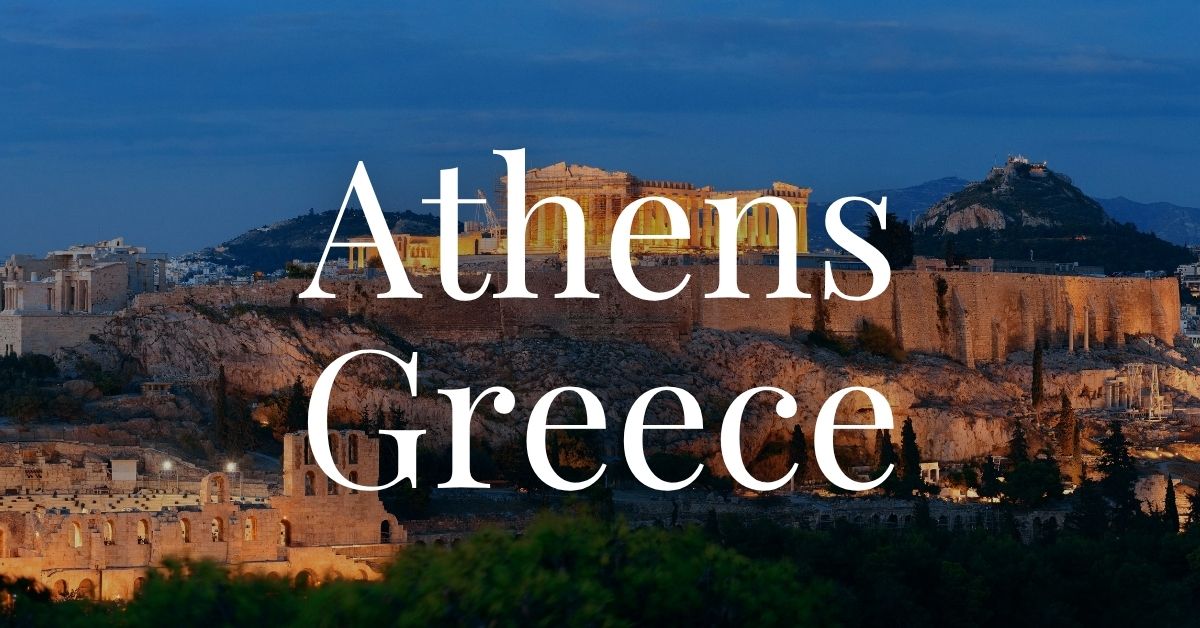 ruins in Athens, Greece lit up at dusk