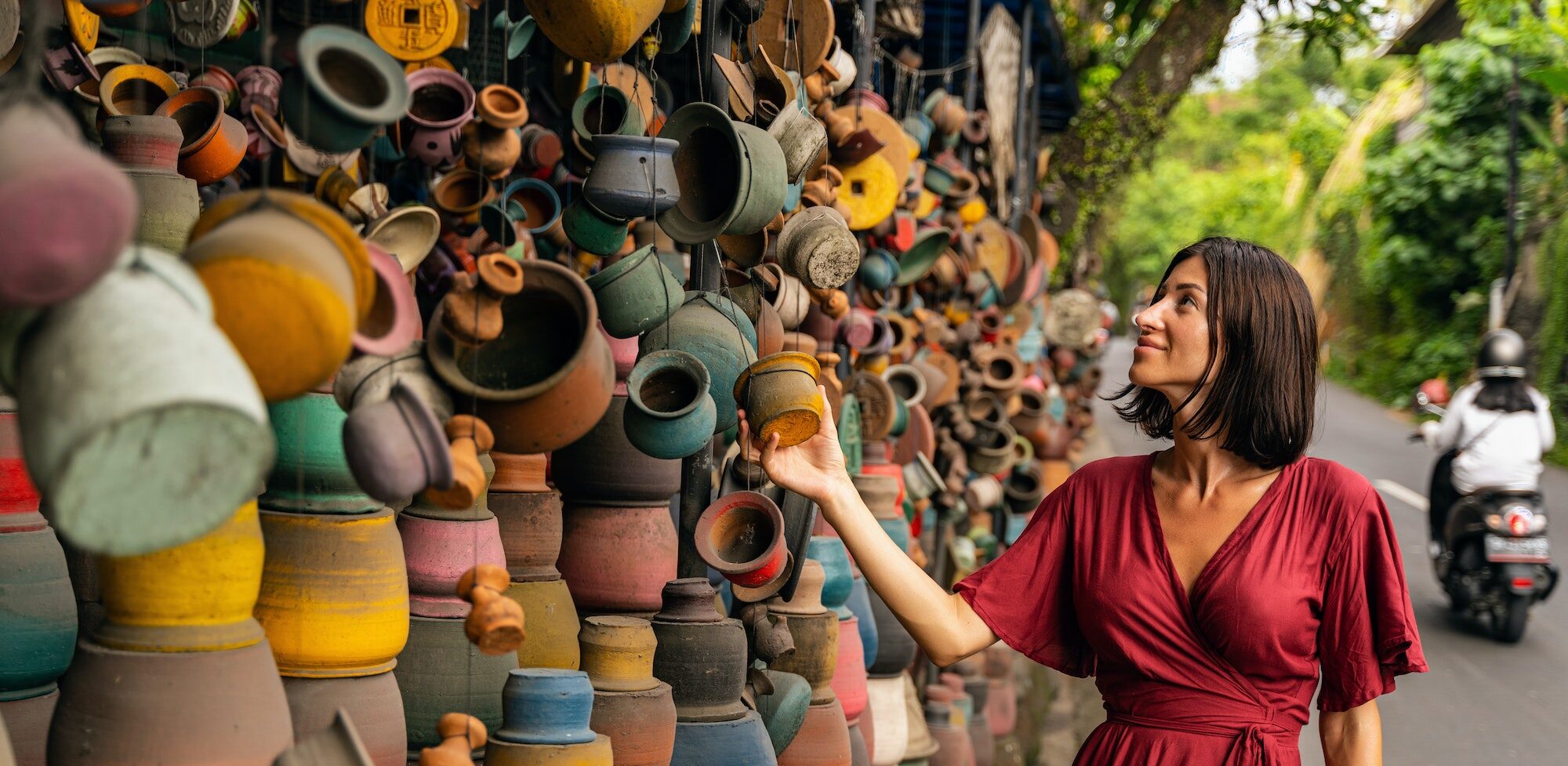 Young woman exploring a colorful local market during cultural travels
