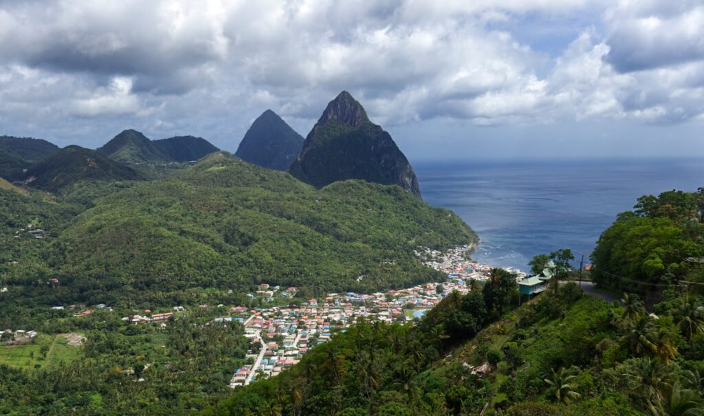 Discover the lush green landscapes and iconic Pitons of Soufriere, Saint Lucia from above.