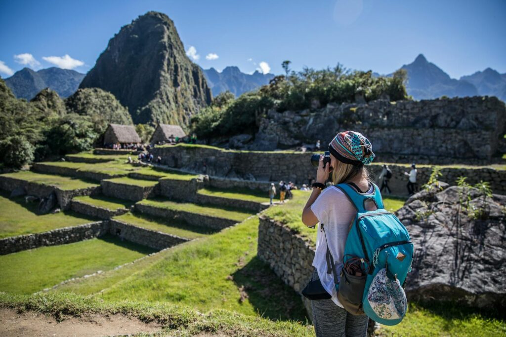 A traveler captures the beauty of Machu Picchu on a sunny day in Peru.