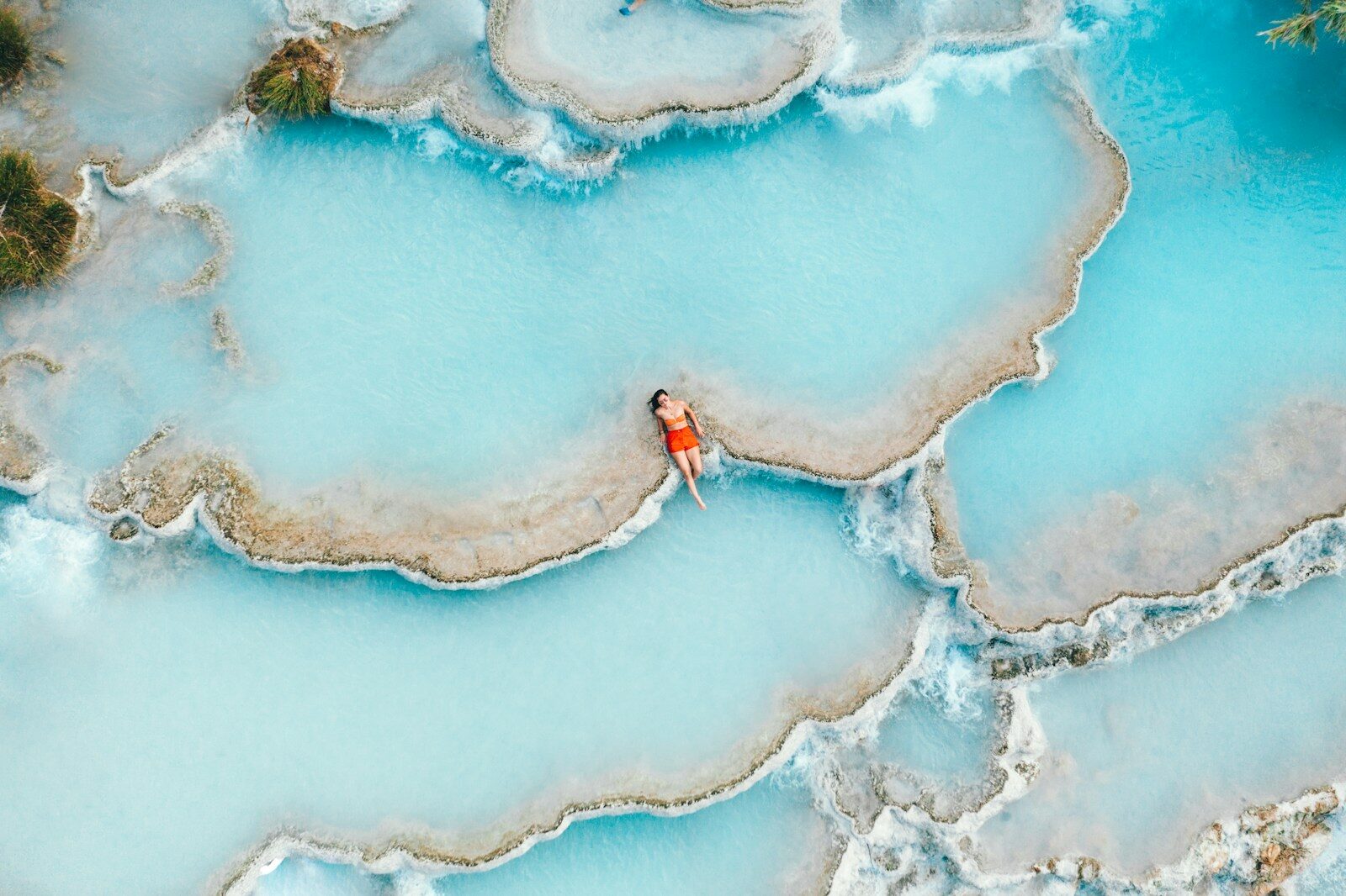 woman sitting in thermal hot spring