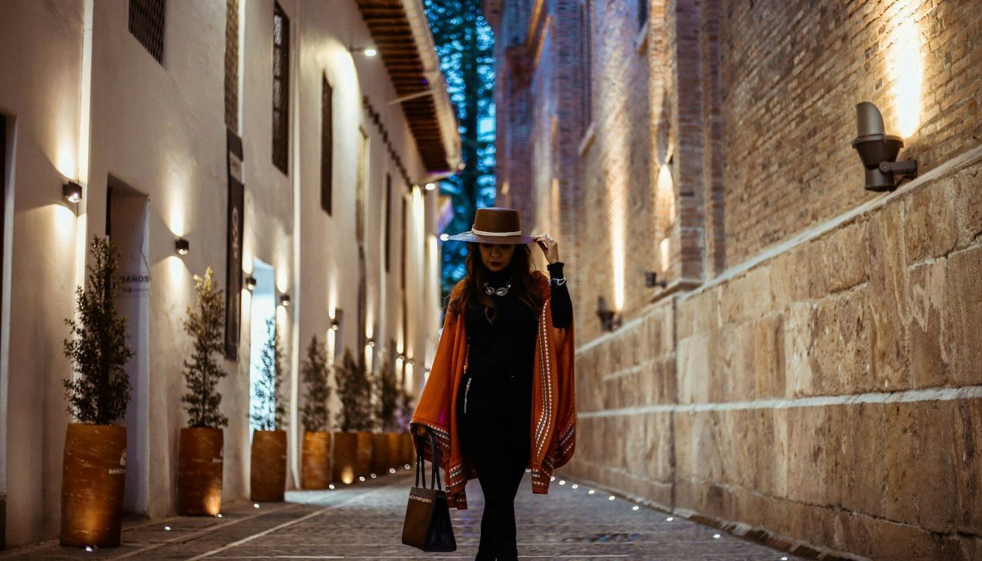 woman in black dress and brown hat