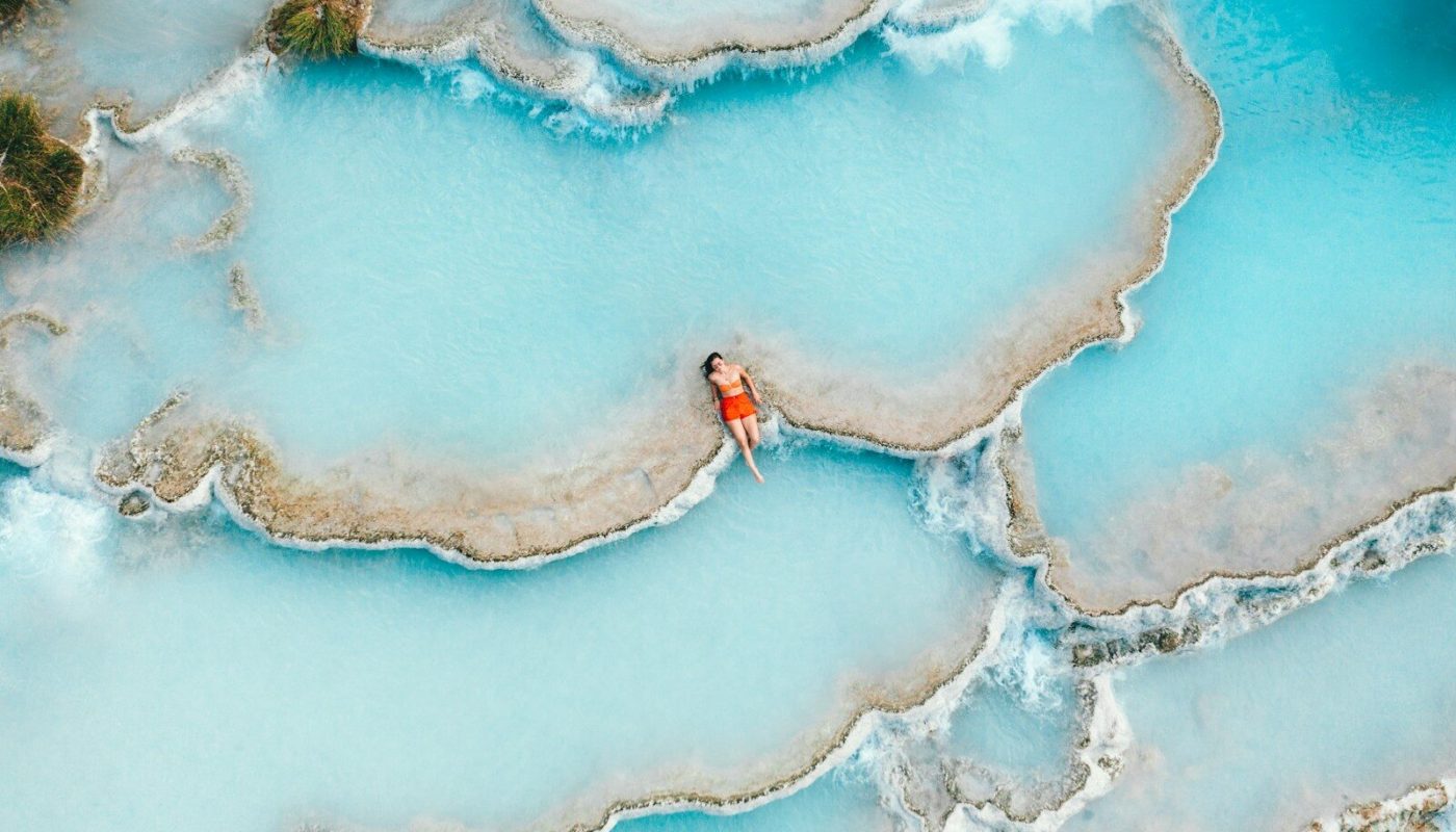 woman sitting in thermal hot spring
