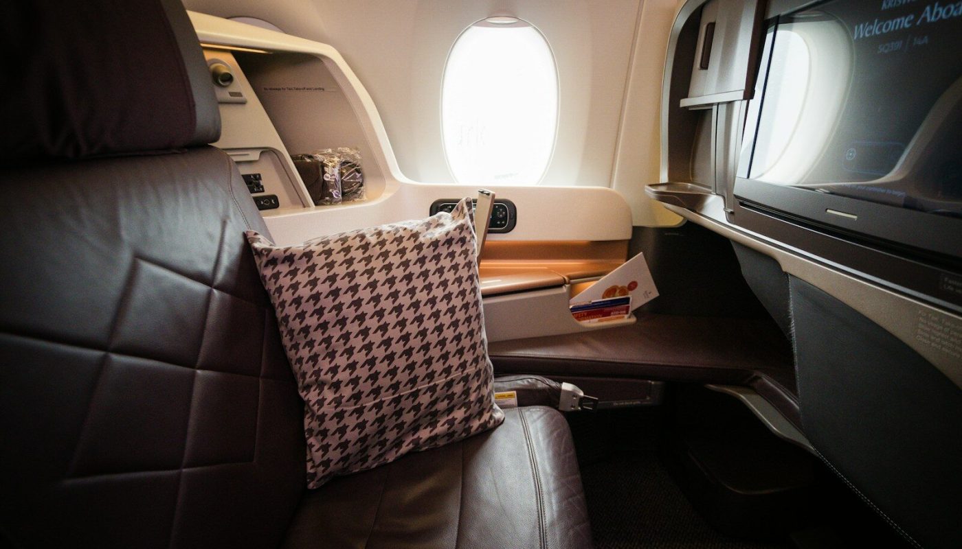 A seat in an airplane with a television on it